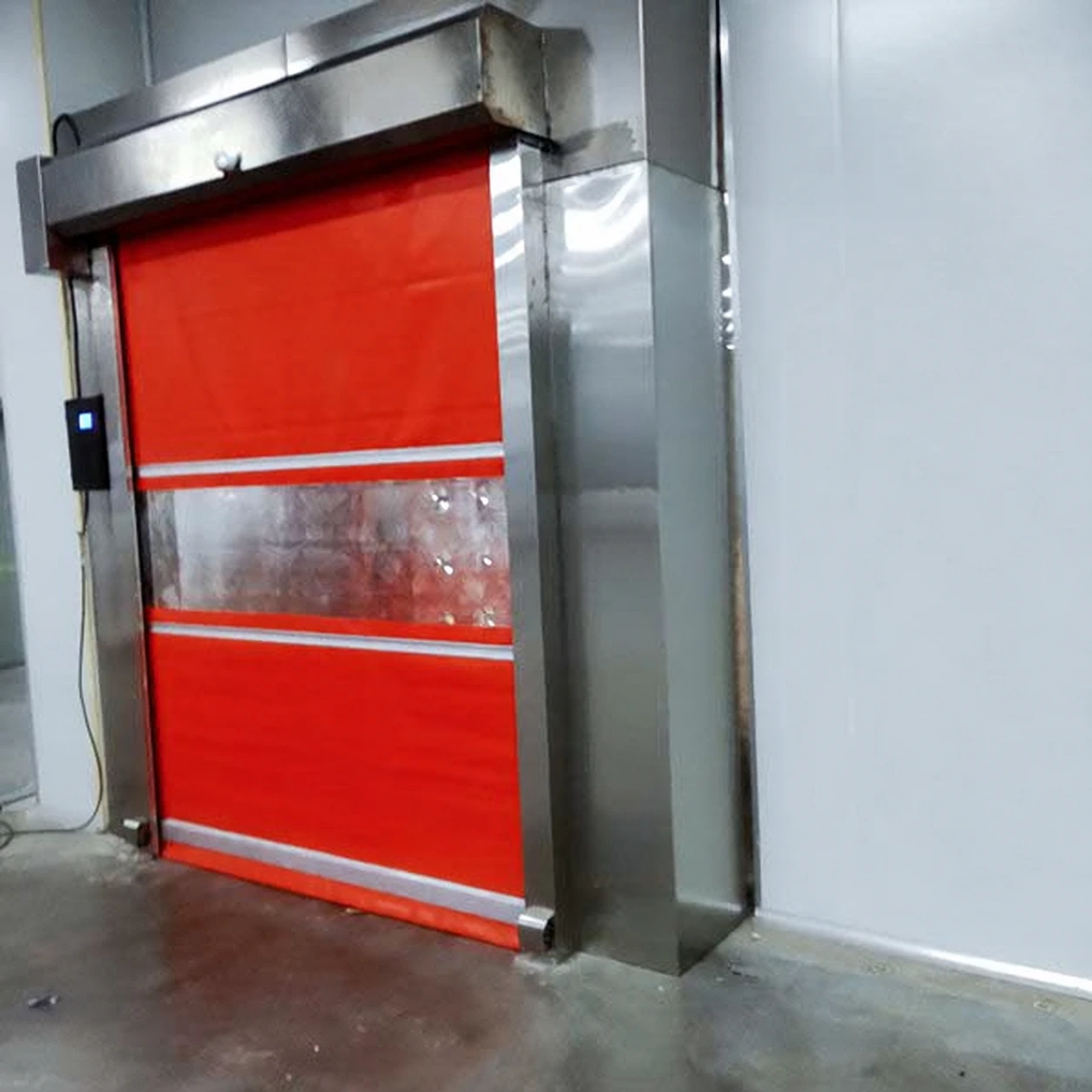 Industrial air shower entrance with a red rolling door
