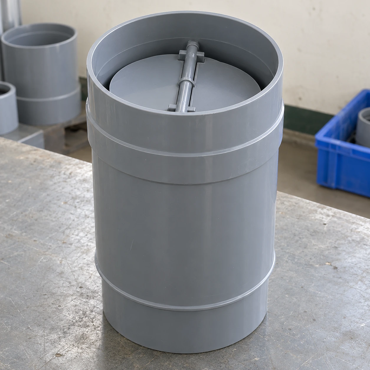 Grey rigid PVC round backdraft damper with socket connection and internal gravity flaps