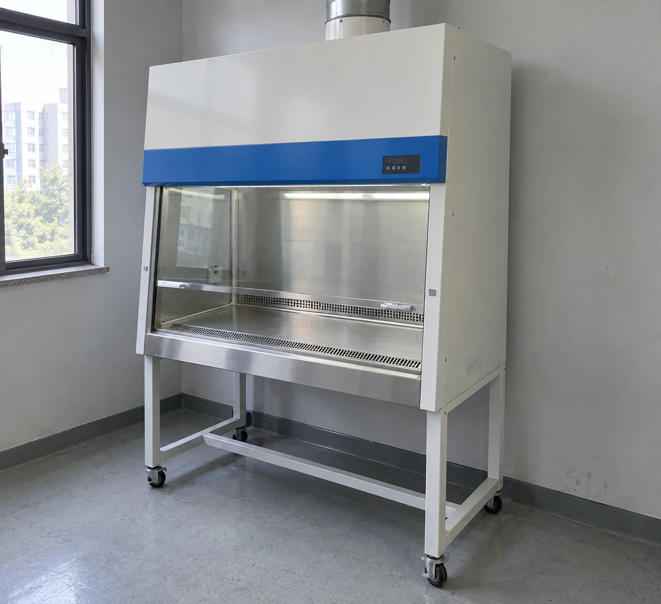 Biological safety cabinet installed in a modest laboratory with clear space around its front opening and overhead filter section