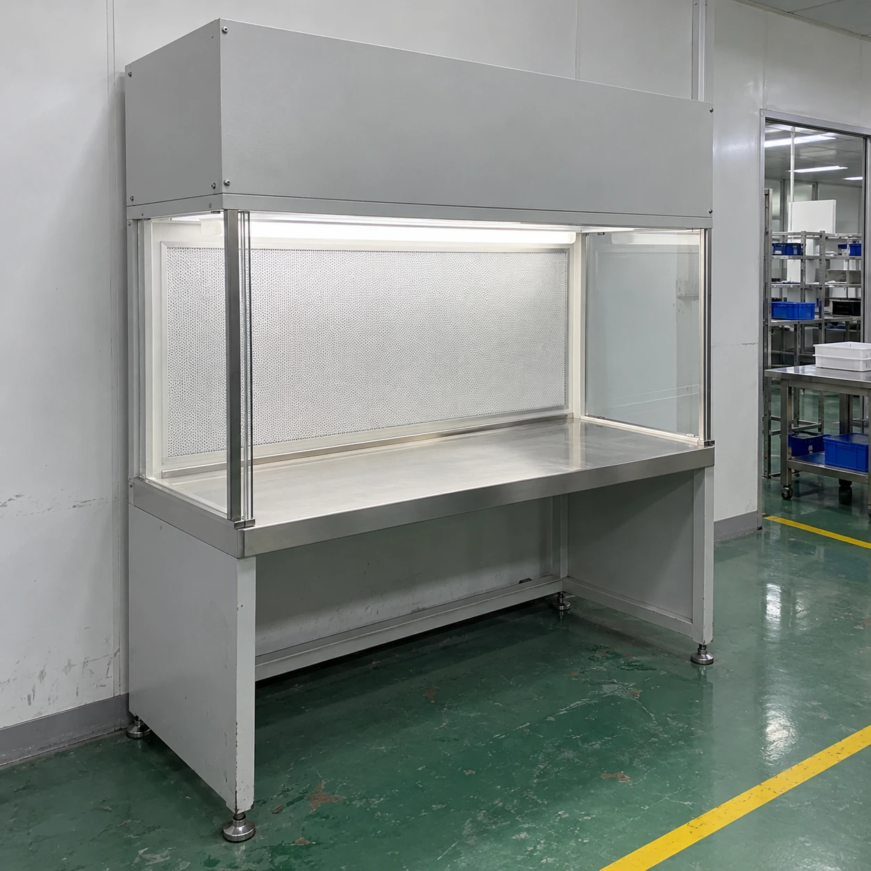 Vertical clean bench installed beside a clear aisle in a controlled assembly room