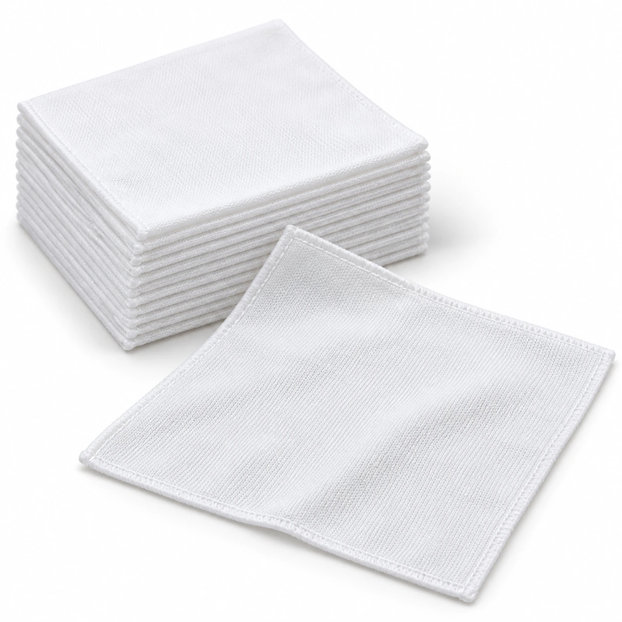 White knitted polyester industrial wiping cloths with a flat unfolded sheet and stacked wipes