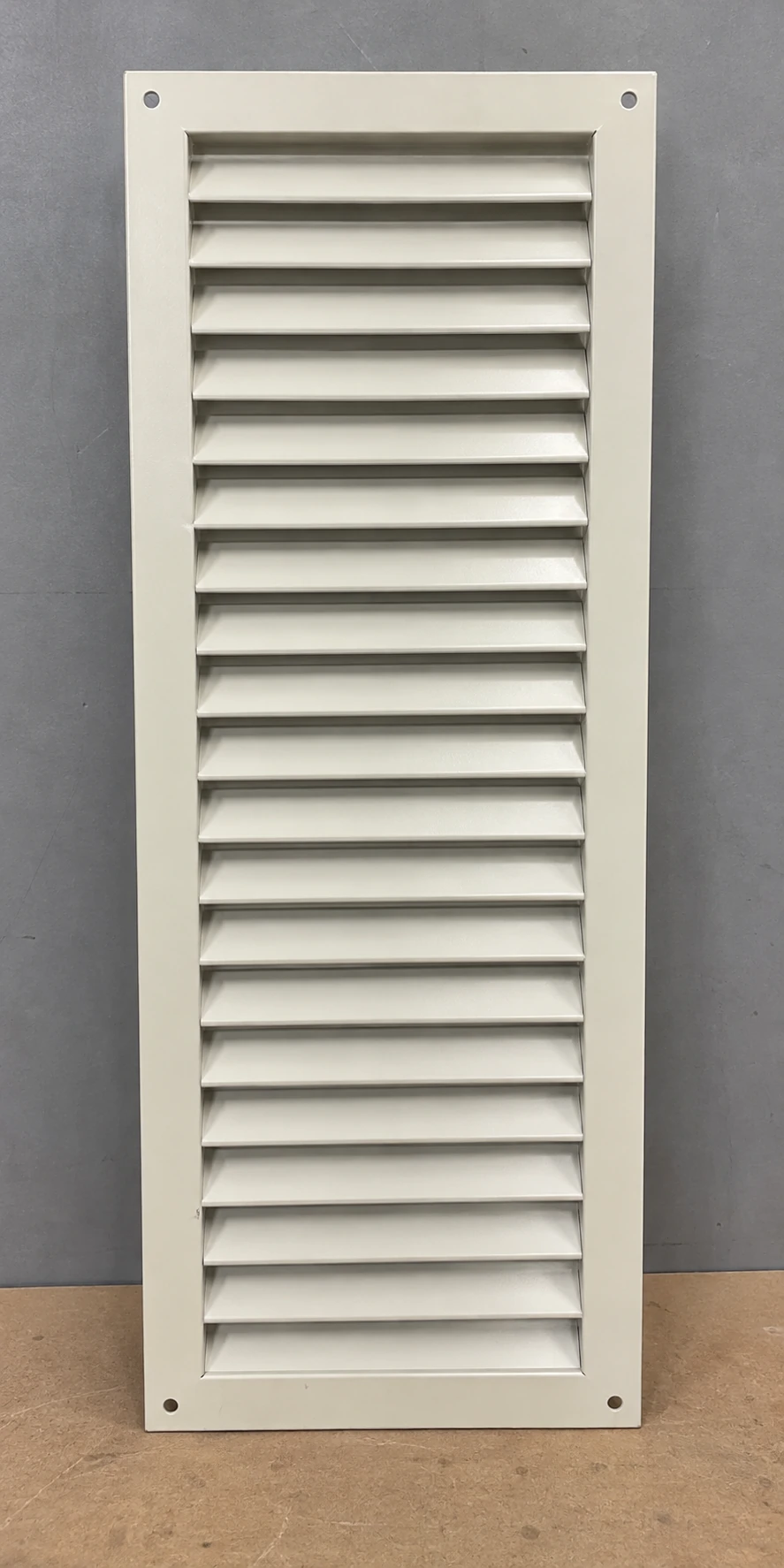 Tall cream-painted steel return grille with horizontal louvers and plain screw flange
