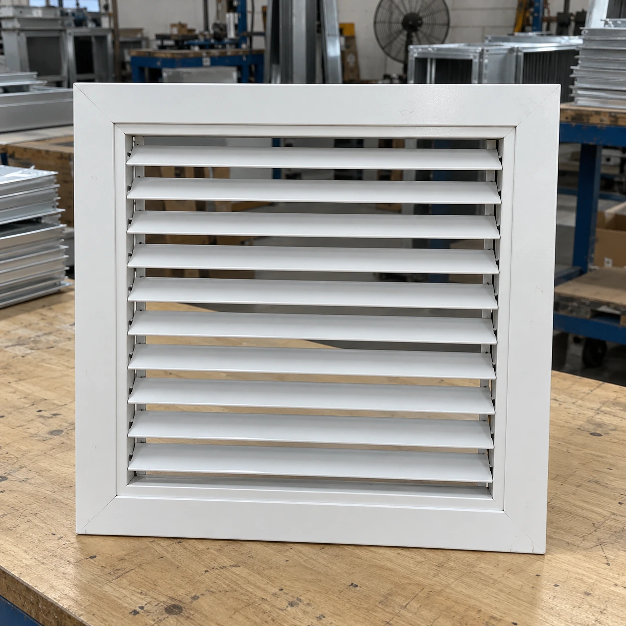 Square fourteen-inch white return grille with a removable blade core