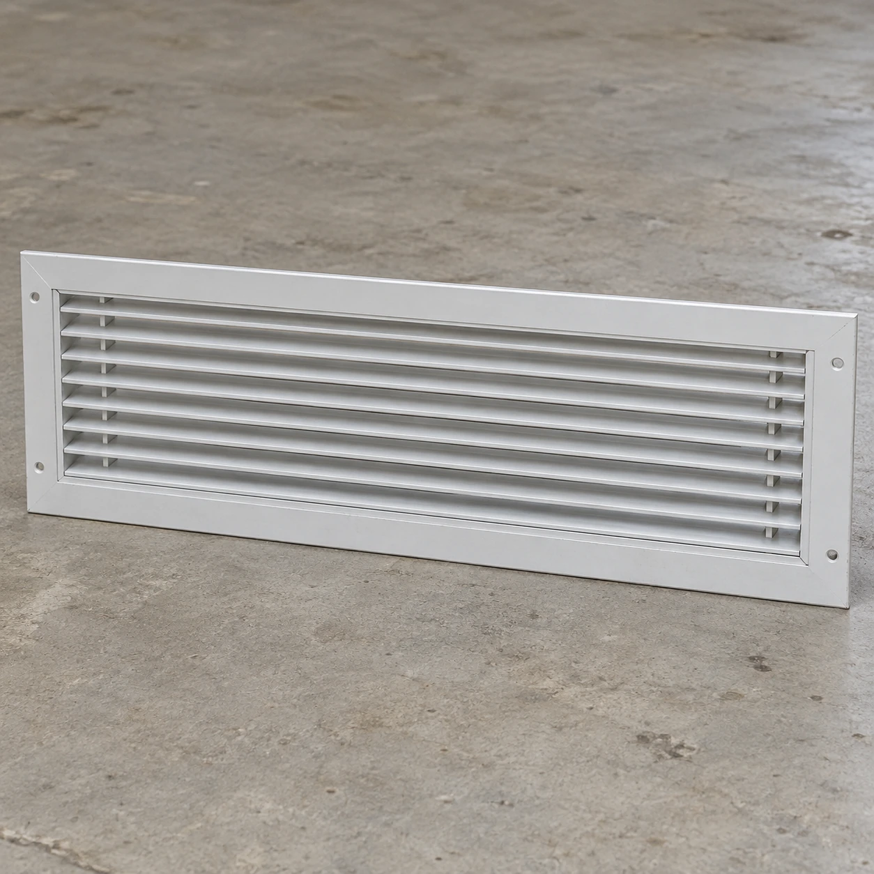 Wide white removable return grille for a commercial fan-coil bulkhead