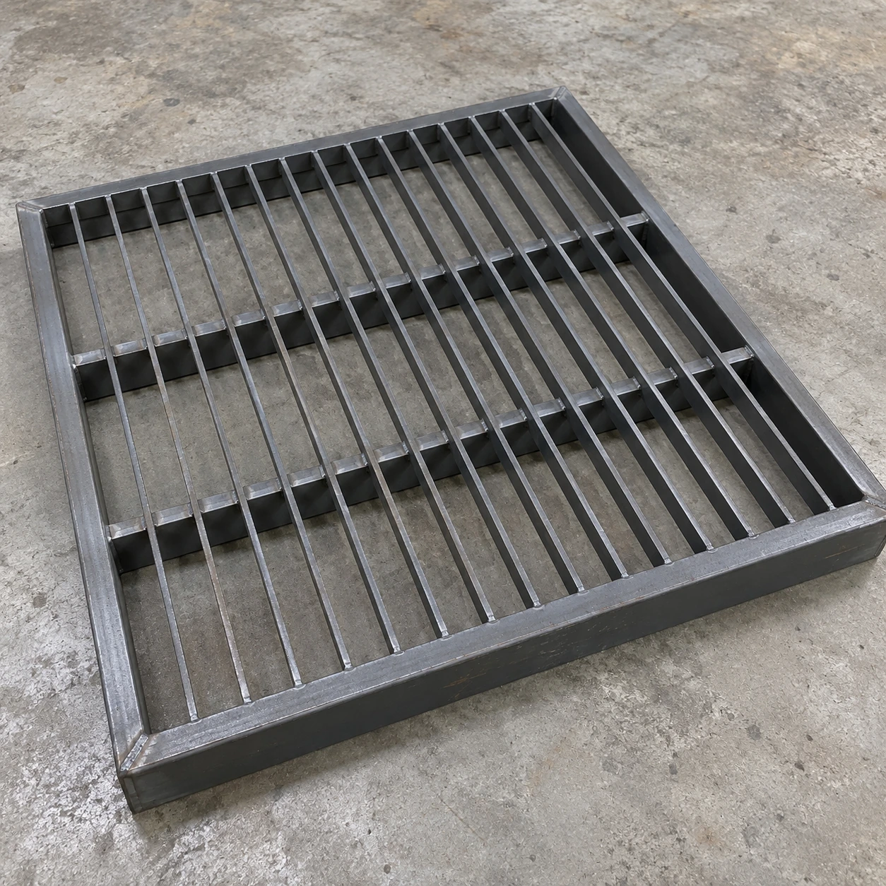 Heavy-duty steel floor return grille with deep perimeter support frame and underside reinforcement